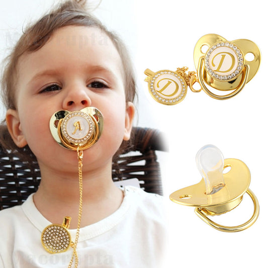 Silicone baby pacifier with a gold initial letter